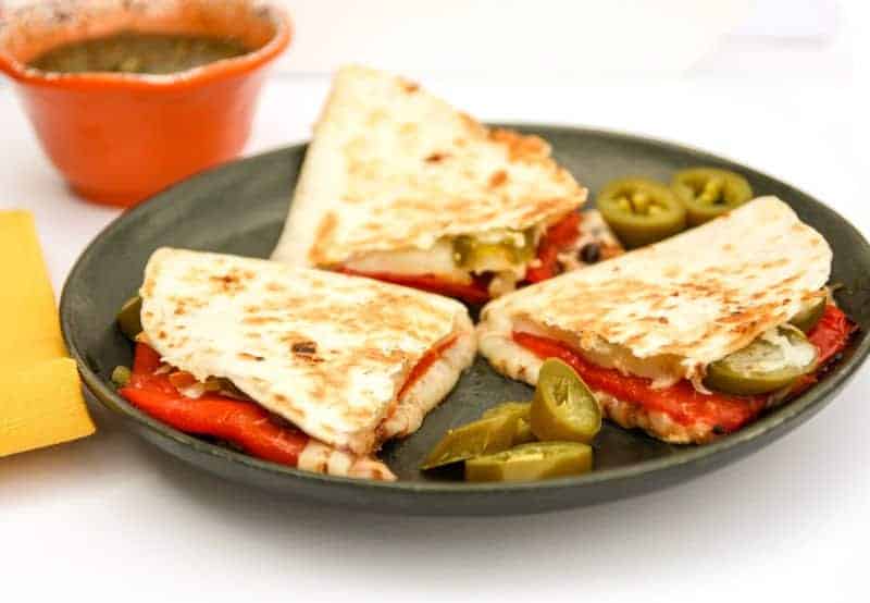 A plate of quesadillas on a table, with Quesadilla and Cheese