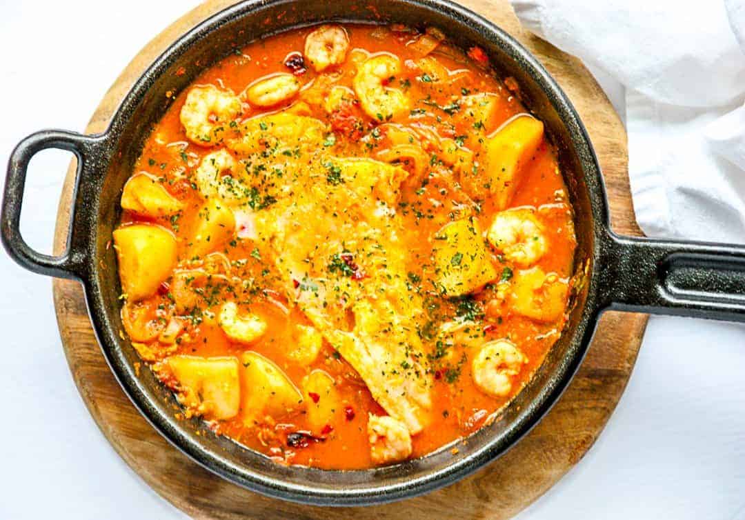 A pan of food, with fish and shrimp