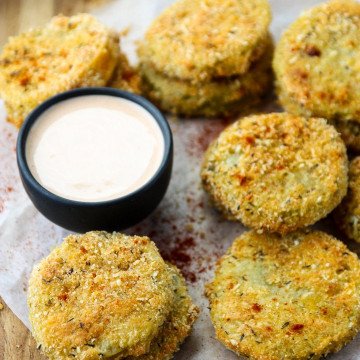 Oven Fried Green Tomatoes on parchment paper on a table